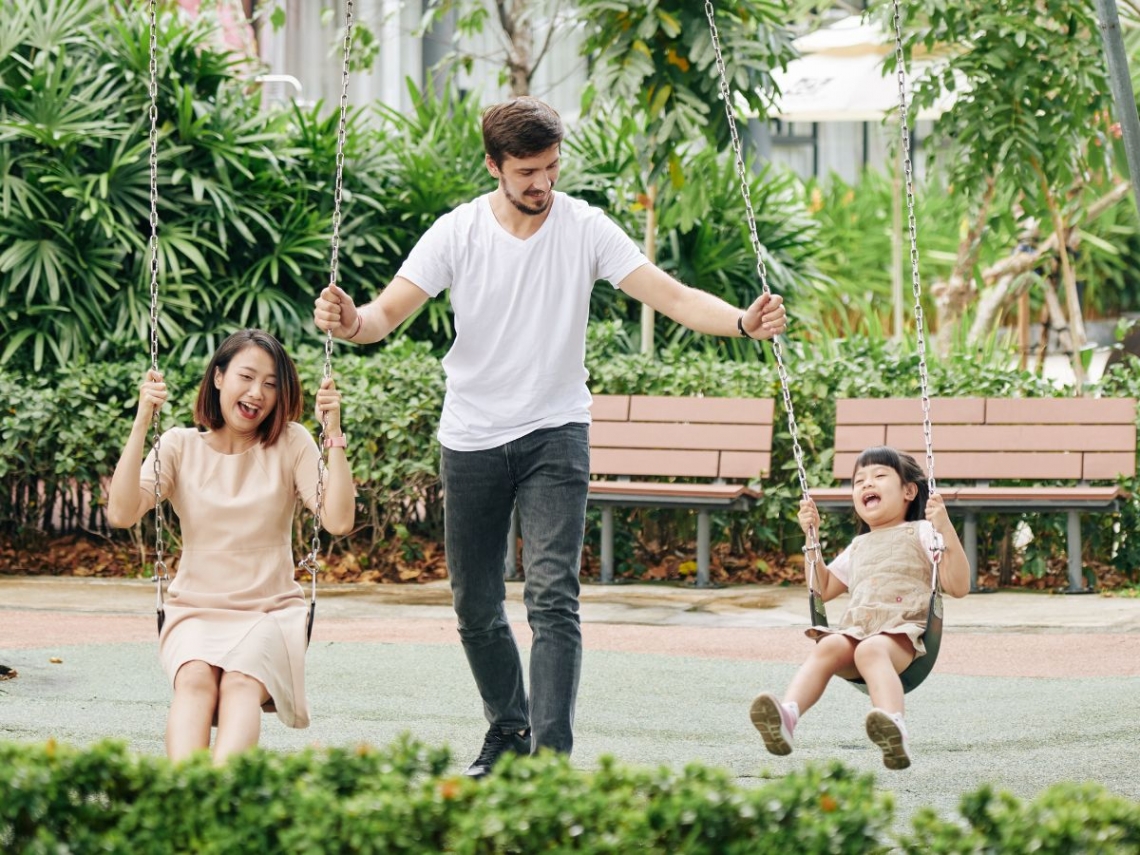 A family having fun playing on swings.jpg